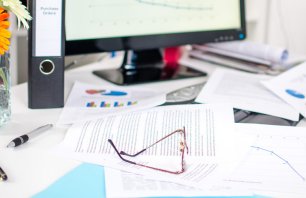 Desk cluttered with business documents