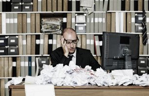 Tired Businessman at a messy office